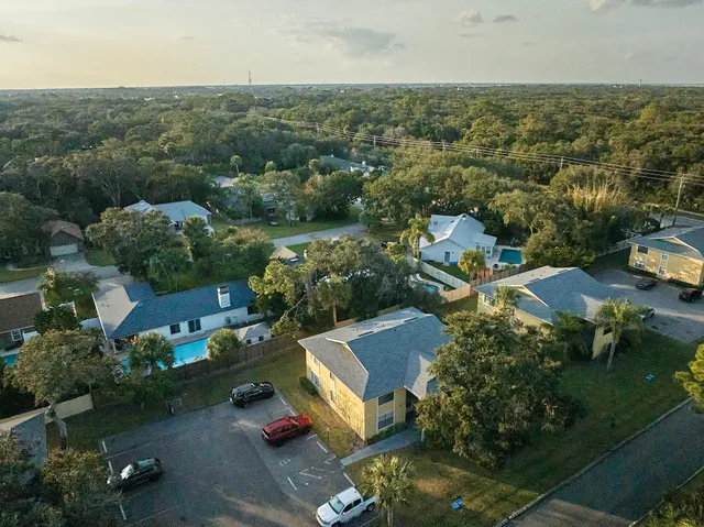 an aerial view of residential building and lake