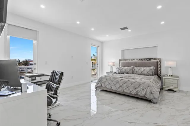 a living room with a bed furniture and a flat screen tv