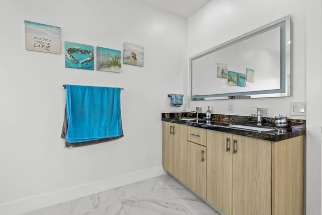 a kitchen with sink and cabinets