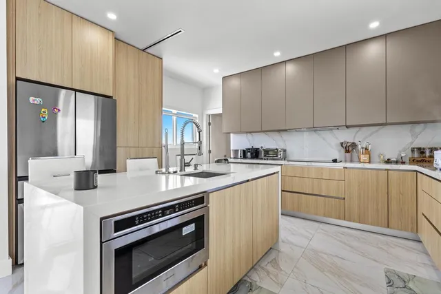 a kitchen with a sink stove and cabinets