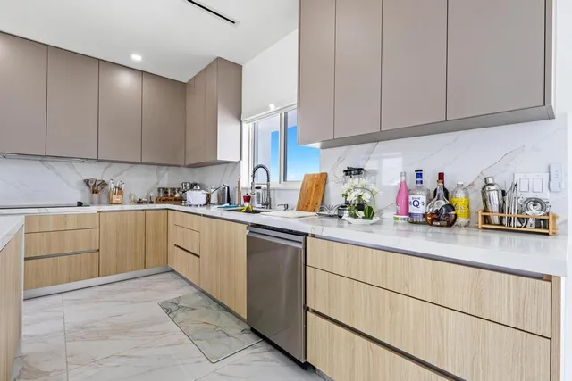 a kitchen with cabinets and window