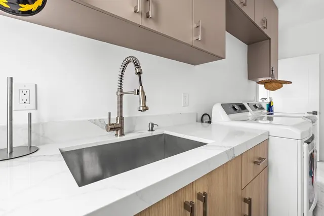 a kitchen with stainless steel appliances a sink a stove and a refrigerator with wooden floor