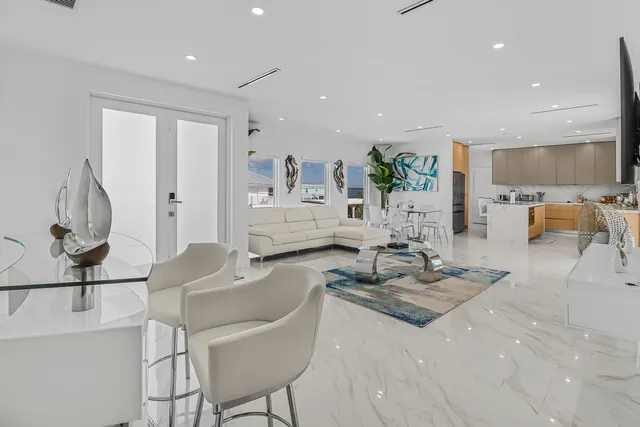 a living room with furniture and a chandelier