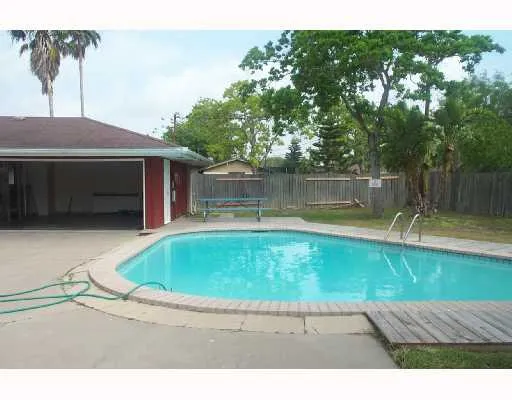 a swimming pool with outdoor seating and yard