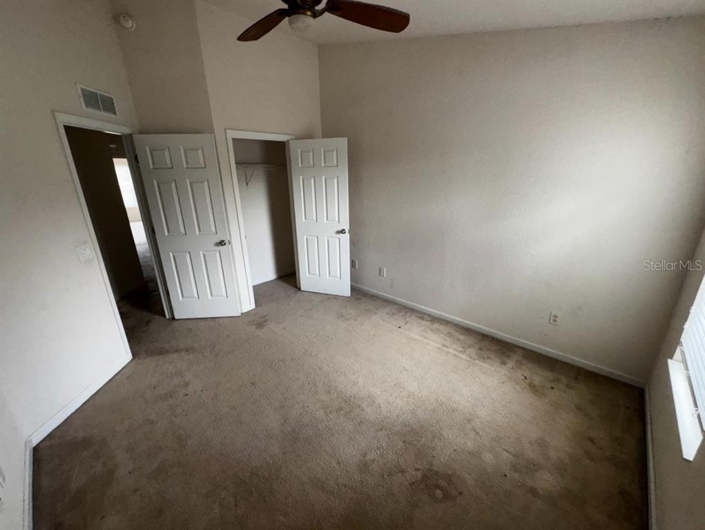 4202 Southwest 55th Circle, Unit C Ocala, FL 34474 - Photo 11 of 15 an empty room with a door