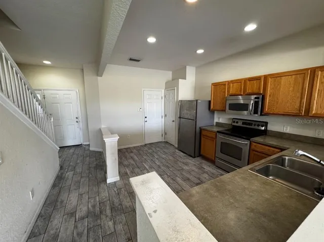 a kitchen with a sink and stainless steel appliances
