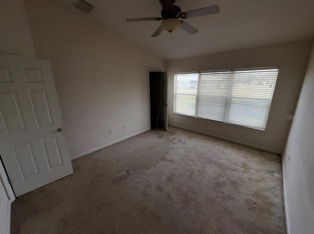 4202 Southwest 55th Circle, Unit C Ocala, FL 34474 - Photo 6 of 15 an empty room with a empty space and windows