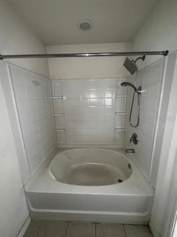 a bathroom with a shower and tub