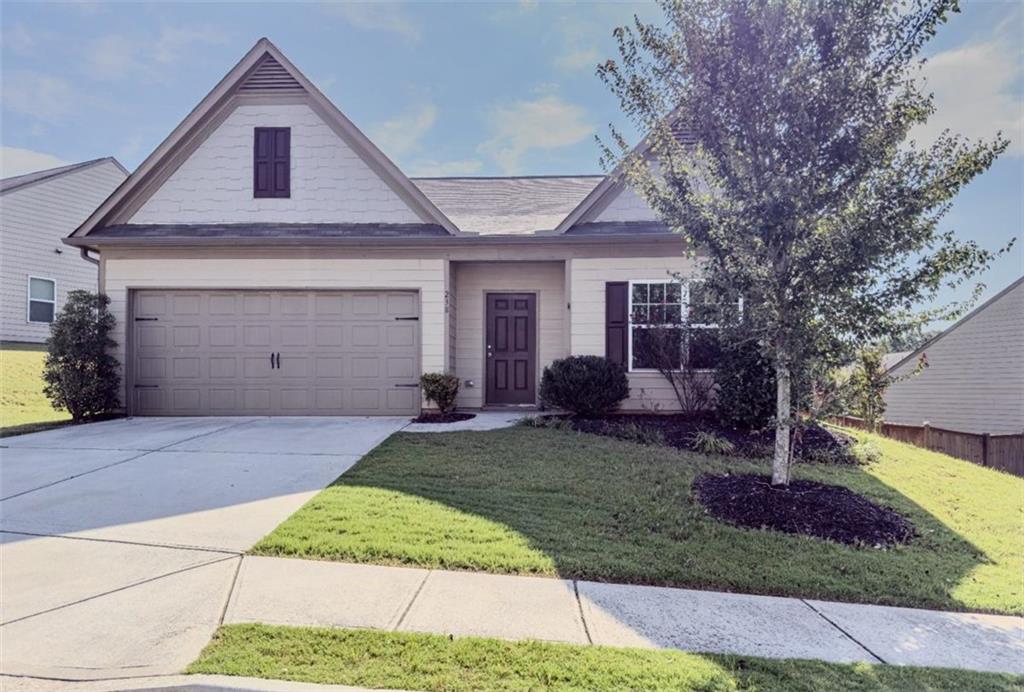 a front view of a house with garden