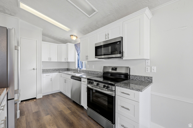 150 West 7500th South, Unit 55 Midvale, UT 84047 - Photo 14 of 28 Kitchen featuring white shaker-style cabinetry, granite-finish countertops, stainless steel appliances, wood-finish flooring, and recessed lighting