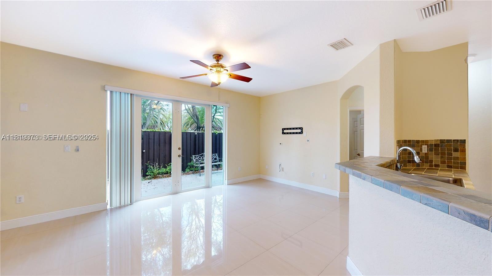 12281 Southwest 121st Terrace Miami, FL 33186 - Photo 12 of 58 a view of a room with a ceiling fan and a window