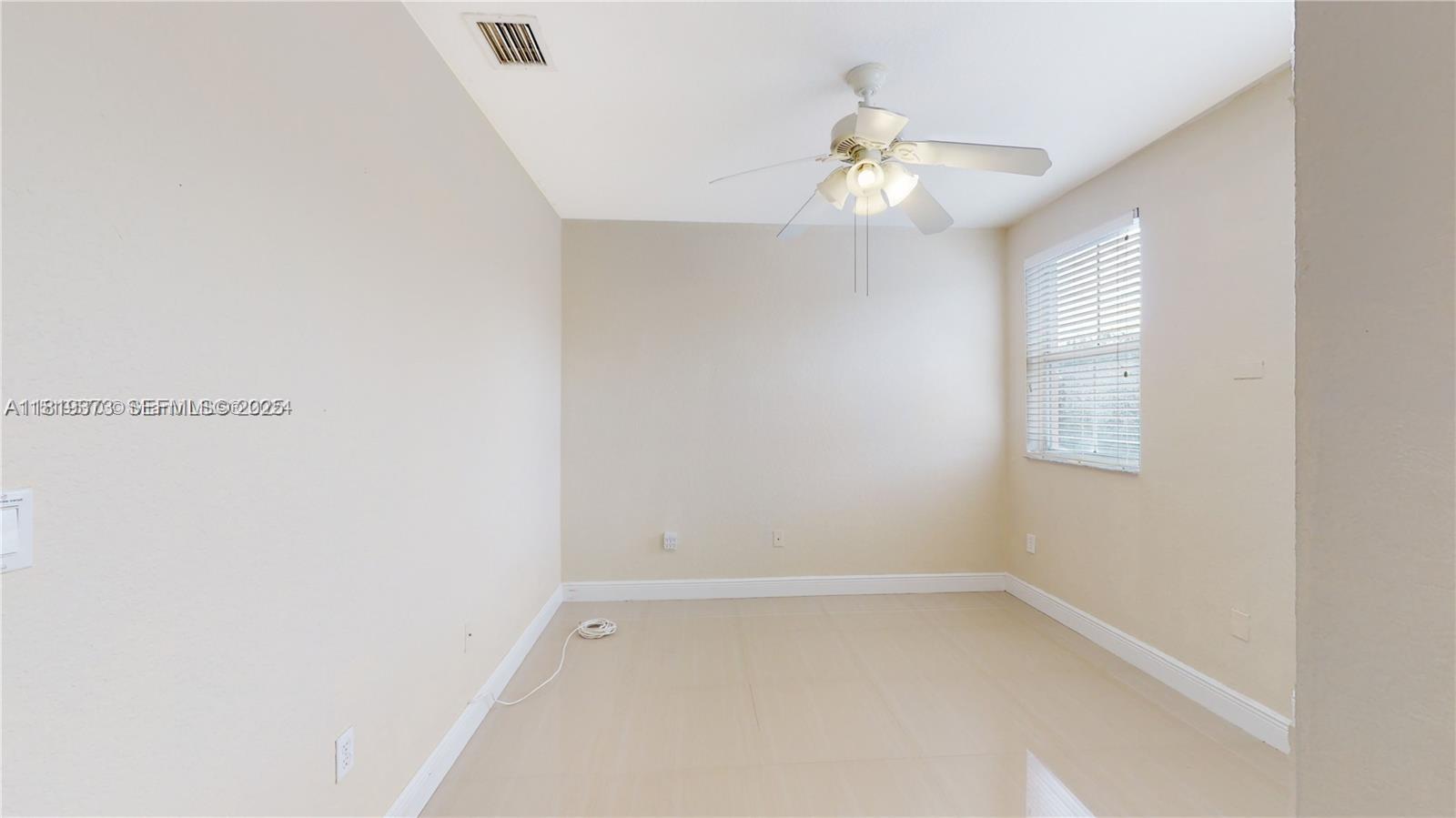 12281 Southwest 121st Terrace Miami, FL 33186 - Photo 18 of 58 an empty room with a window and a fan