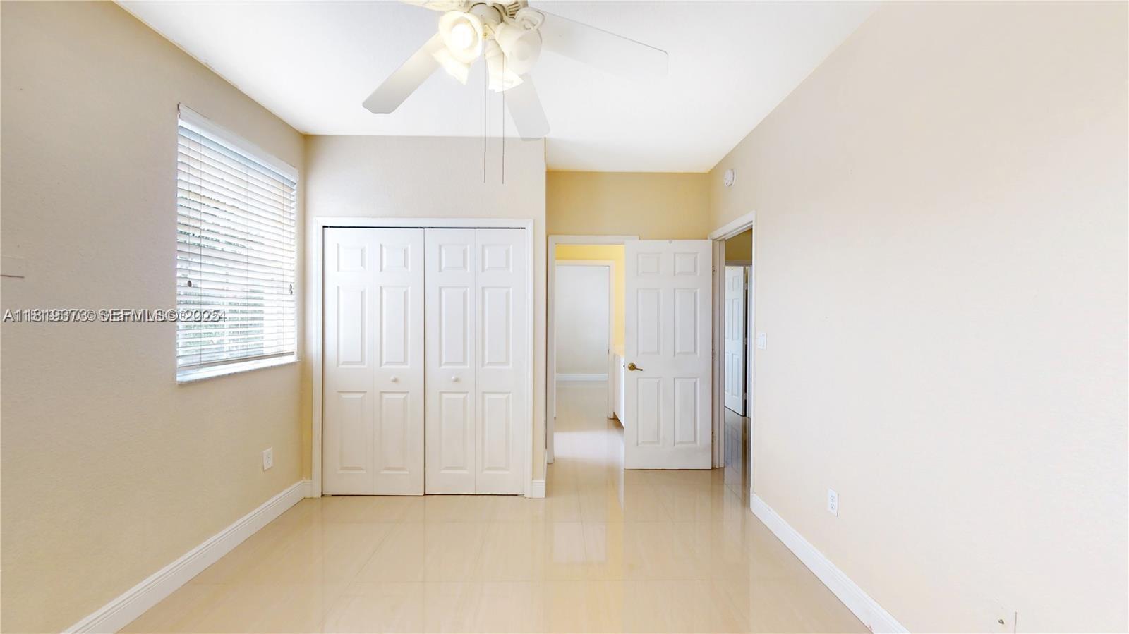 12281 Southwest 121st Terrace Miami, FL 33186 - Photo 19 of 58 a view of an empty room with a window
