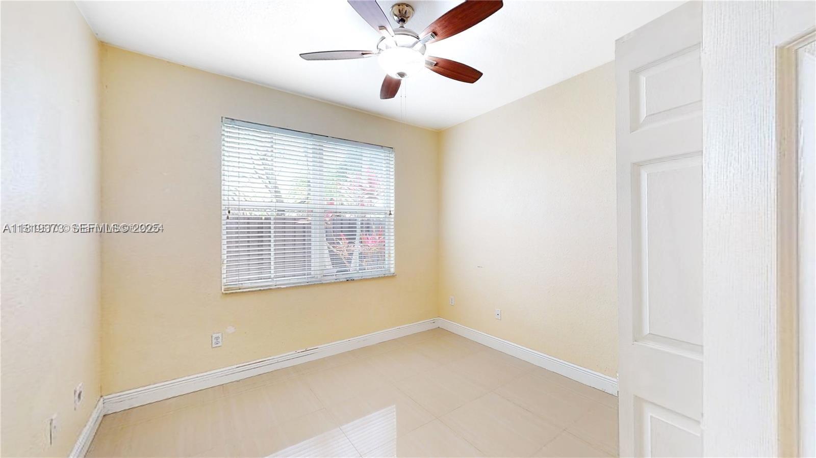 12281 Southwest 121st Terrace Miami, FL 33186 - Photo 24 of 58 a view of an empty room with a window