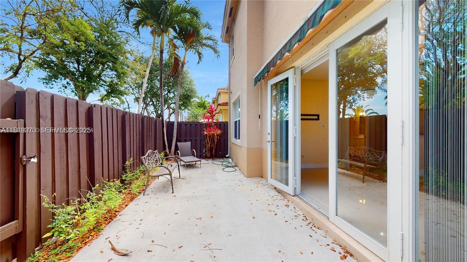12281 Southwest 121st Terrace Miami, FL 33186 - Photo 31 of 58 a backyard of a house with table and chairs