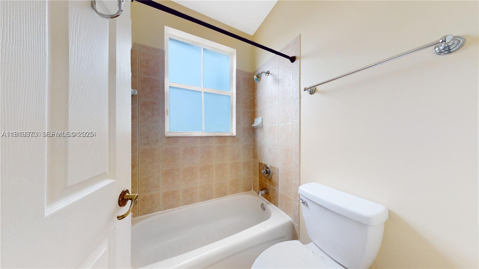 12281 Southwest 121st Terrace Miami, FL 33186 - Photo 33 of 58 a bathroom with a toilet and a bathtub