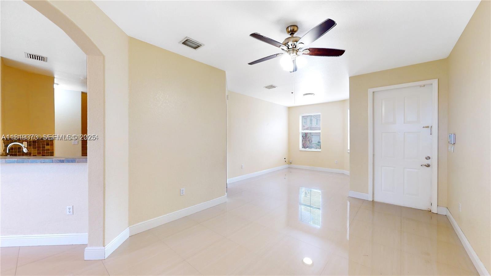 12281 Southwest 121st Terrace Miami, FL 33186 - Photo 7 of 58 a view of an empty room with a ceiling fan