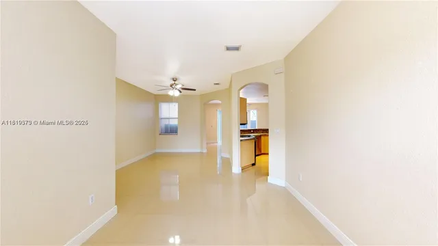 a kitchen with stainless steel appliances granite countertop a sink and a refrigerator