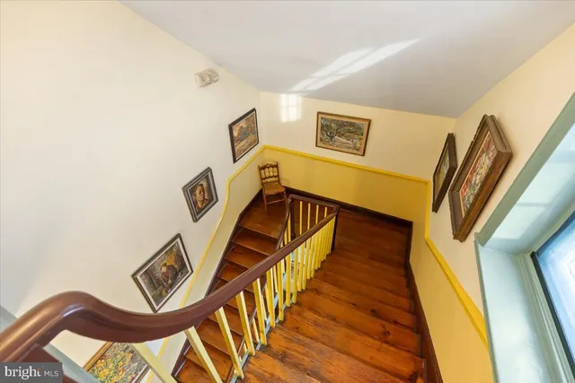 a bedroom with furniture and a book shelf