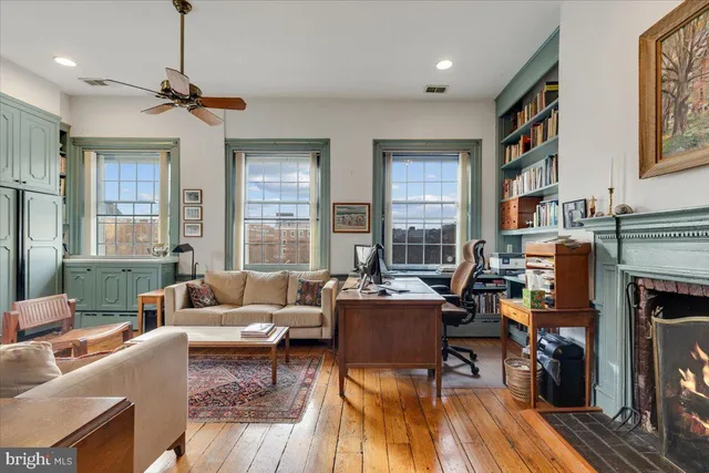 a view of a hallway with wooden floor and a chandelier