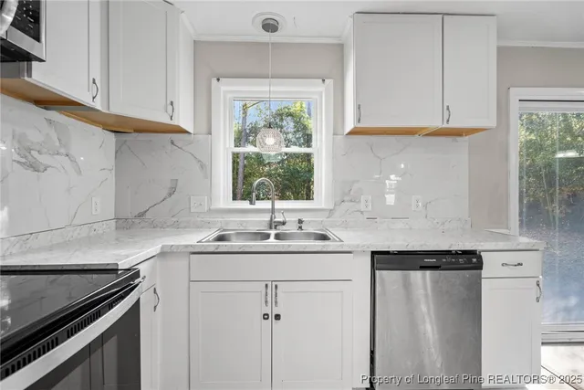a kitchen with a stove window and cabinets