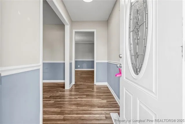 a view of a hallway view with wooden floor and staircase