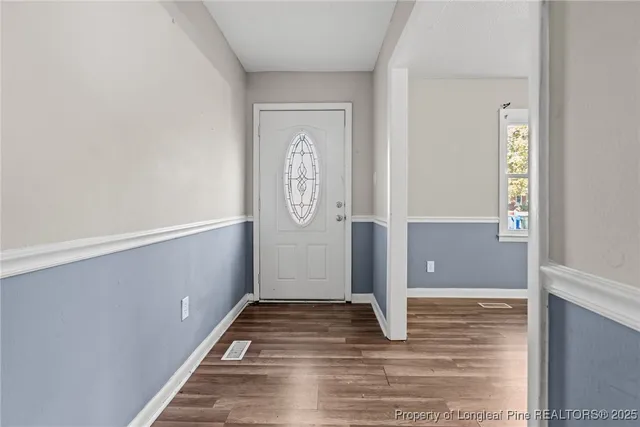 a view of a hallway with wooden floor