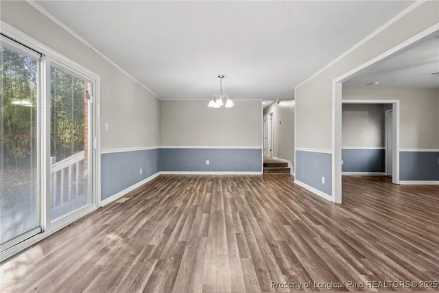 a kitchen with stainless steel appliances granite countertop a refrigerator sink and white cabinets