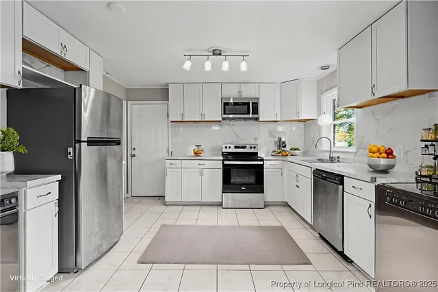 a kitchen with stainless steel appliances granite countertop a refrigerator sink and cabinets