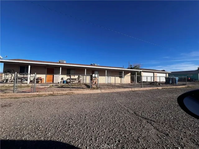 a view of house with yard and outdoor seating