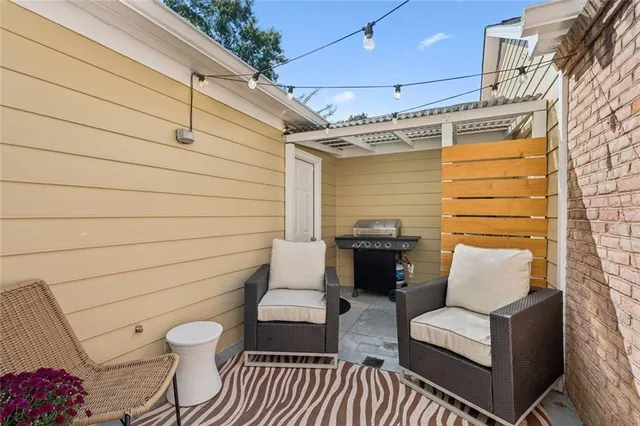 a view of a patio with couches and table and chairs