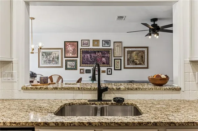 a kitchen with a sink a stove and cabinets