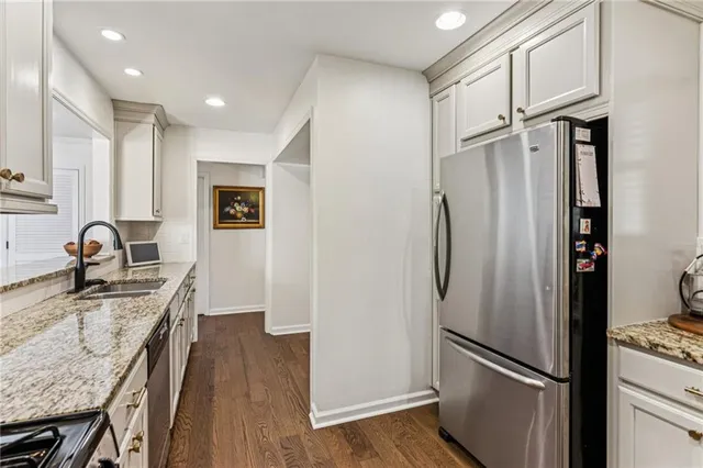 a kitchen with stainless steel appliances granite countertop a refrigerator and a sink