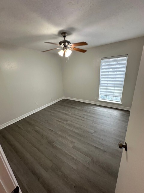 3400 Timmons Lane, Unit 24 Houston, TX 77027 - Photo 12 of 21 an empty room with wooden floor fan and windows