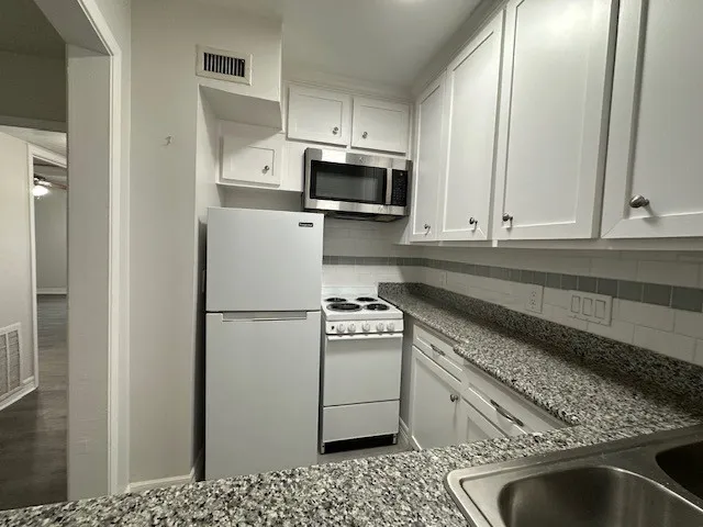 a view of a house with entryway and a tree