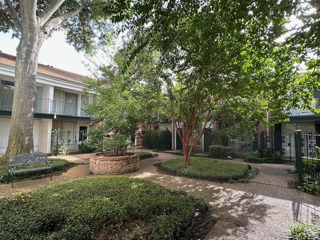 3400 Timmons Lane, Unit 24 Houston, TX 77027 - Photo 16 of 21 a backyard of a house with fountain table and chairs