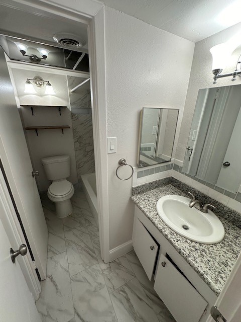 3400 Timmons Lane, Unit 24 Houston, TX 77027 - Photo 4 of 21 a bathroom with a granite countertop sink a toilet and a mirror