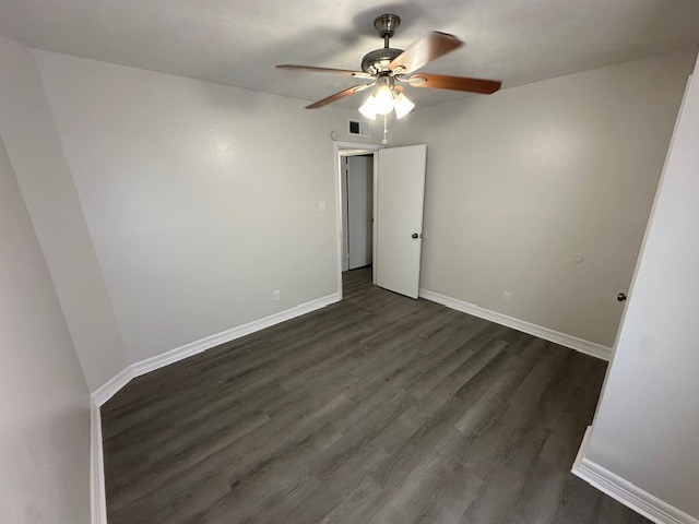 3400 Timmons Lane, Unit 24 Houston, TX 77027 - Photo 6 of 21 an empty room with wooden floor fan and window