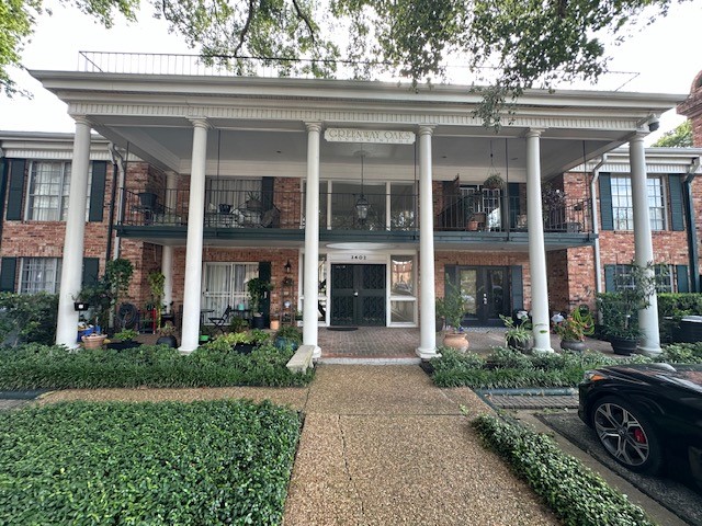 3400 Timmons Lane, Unit 24 Houston, TX 77027 - Photo 10 of 21 front view of a brick house with a large windows