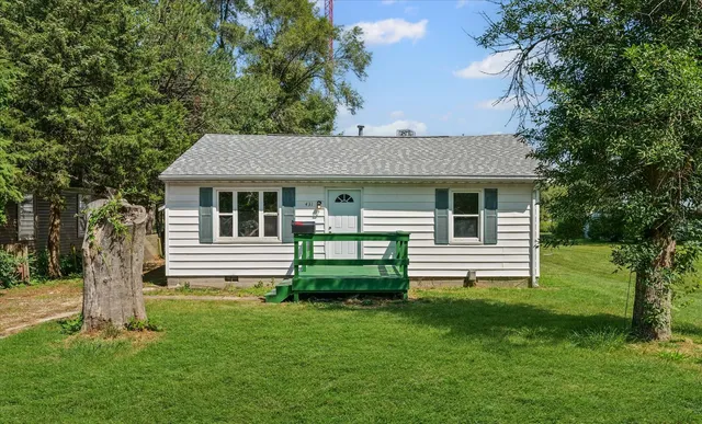 a front view of a house with a garden