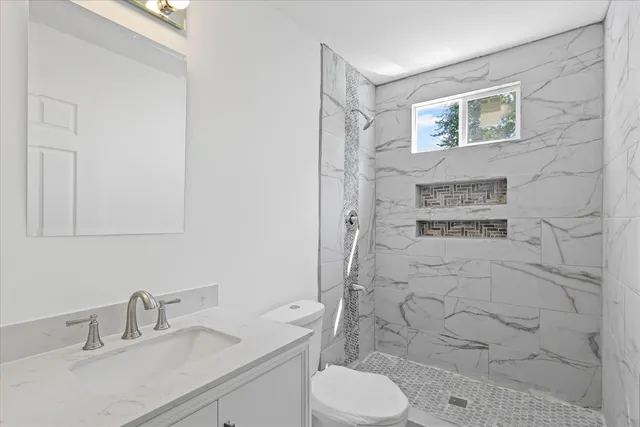a bathroom with a sink toilet and shower