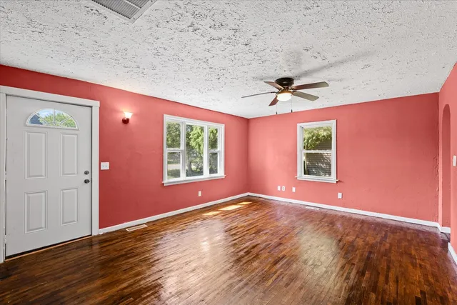 wooden floor in an empty room with a window