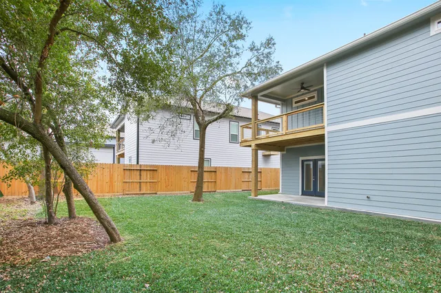 a view of backyard with large trees