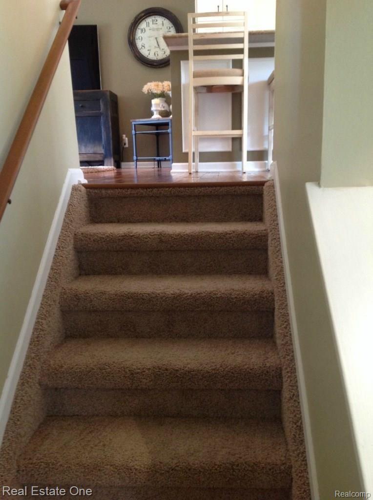 3711 Loon Lake Road Wixom, MI 48393 - Photo 29 of 40 STAIRS UP TO MAIN FLOOR FROM FAMILY ROOM W/NEWER CARPET