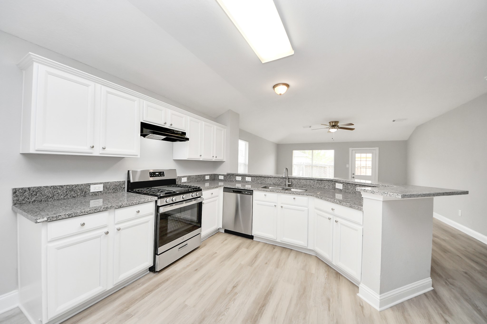 19618 Beachy Court Katy, TX 77449 - Photo 10 of 33 So open and airy, this kitchen feels like a natural extension of the living room—perfect for those who love a modern, bright space!