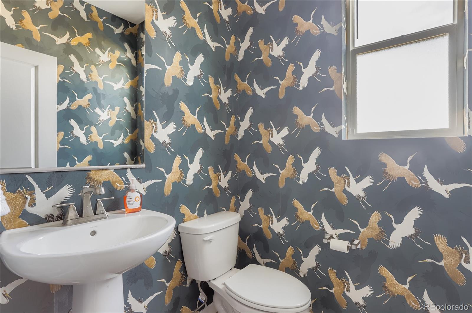 13342 Front Porch Firestone, CO 80504 - Photo 13 of 27 a bathroom with a toilet sink and mirror