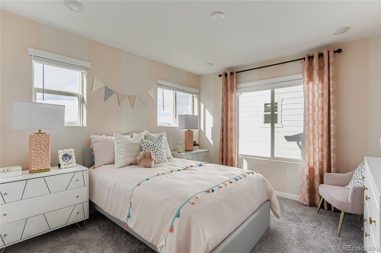 13342 Front Porch Firestone, CO 80504 - Photo 19 of 27 a bedroom with a bed and a couch