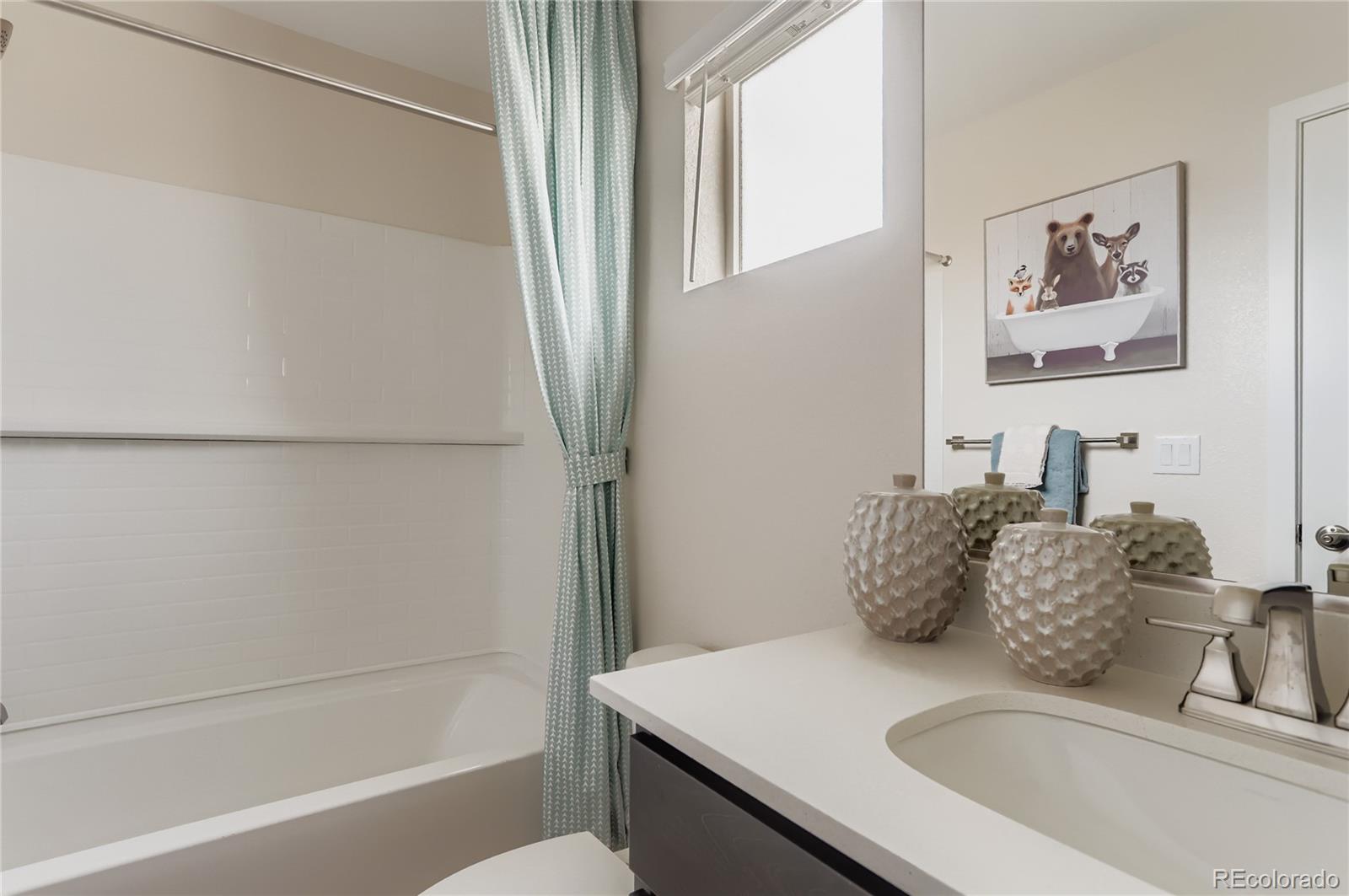 13342 Front Porch Firestone, CO 80504 - Photo 20 of 27 a bathroom with a granite countertop sink a toilet and bathtub