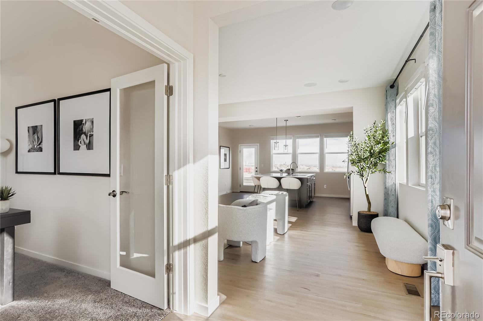13342 Front Porch Firestone, CO 80504 - Photo 4 of 27 a living room with furniture a large window and wooden floor