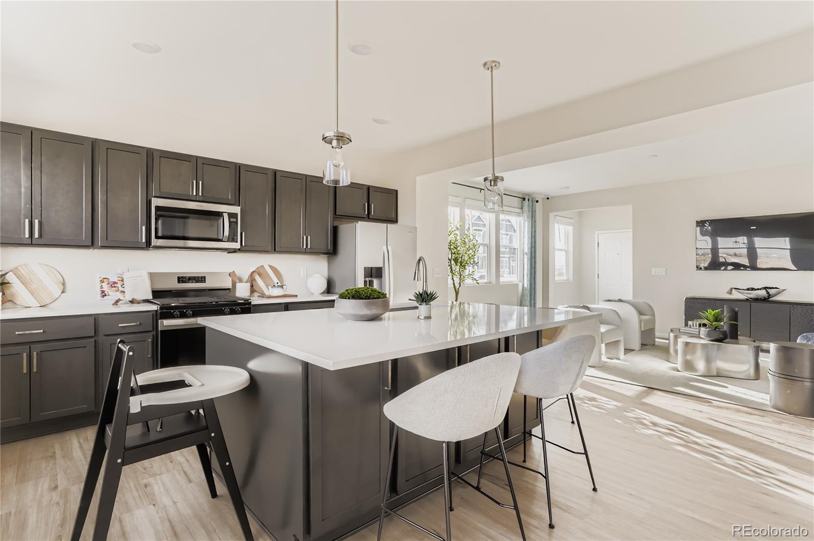 13342 Front Porch Firestone, CO 80504 - Photo 10 of 27 a kitchen with cabinets appliances and a dining table